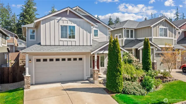 a front view of a house with a garden