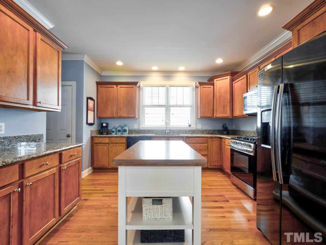 2228 Karns Place Raleigh, NC 27614 - Photo 14 of 62 a kitchen with stainless steel appliances granite countertop a sink stove and refrigerator