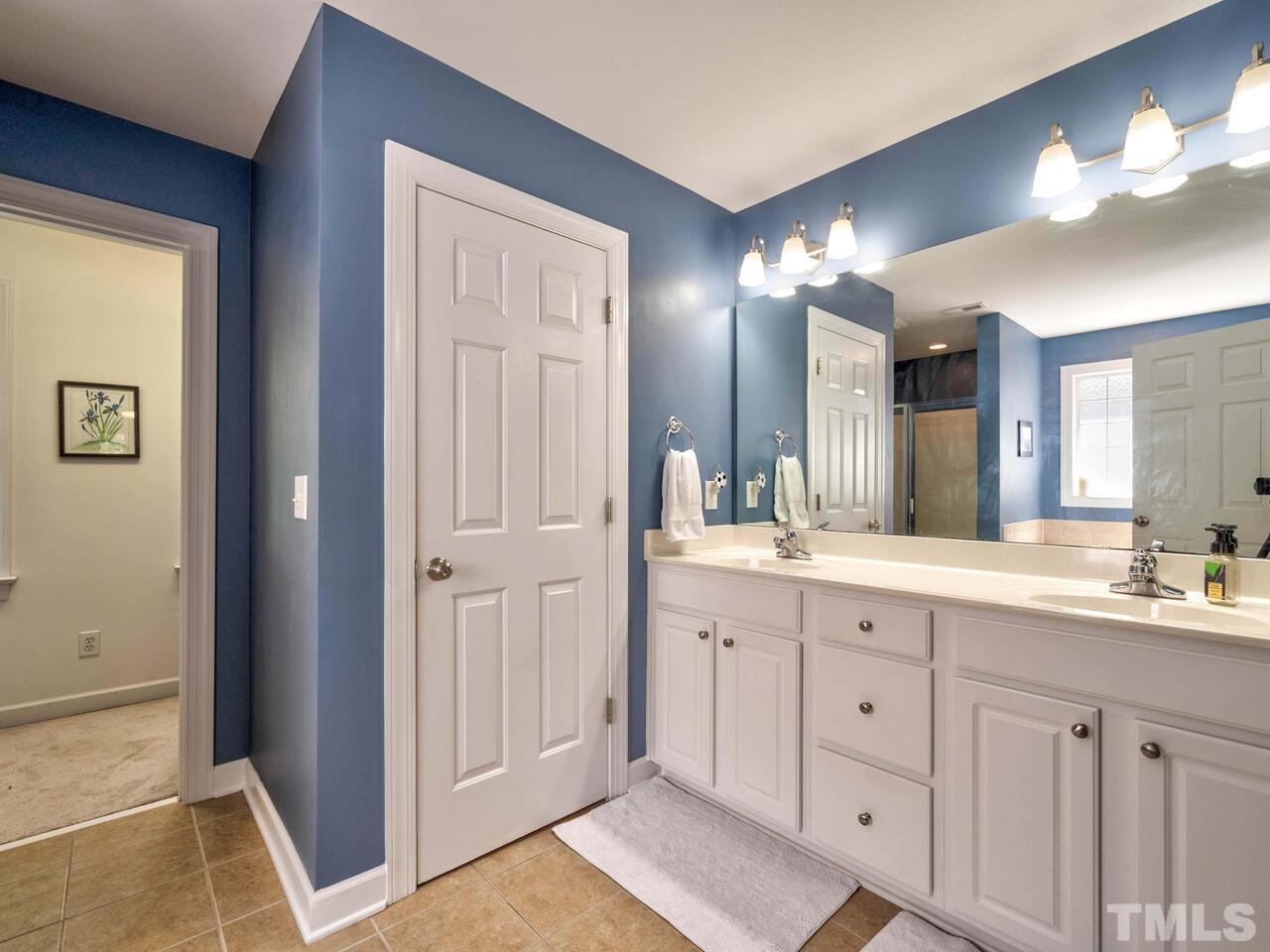 2228 Karns Place Raleigh, NC 27614 - Photo 25 of 62 a spacious bathroom with a double vanity sink and a mirror
