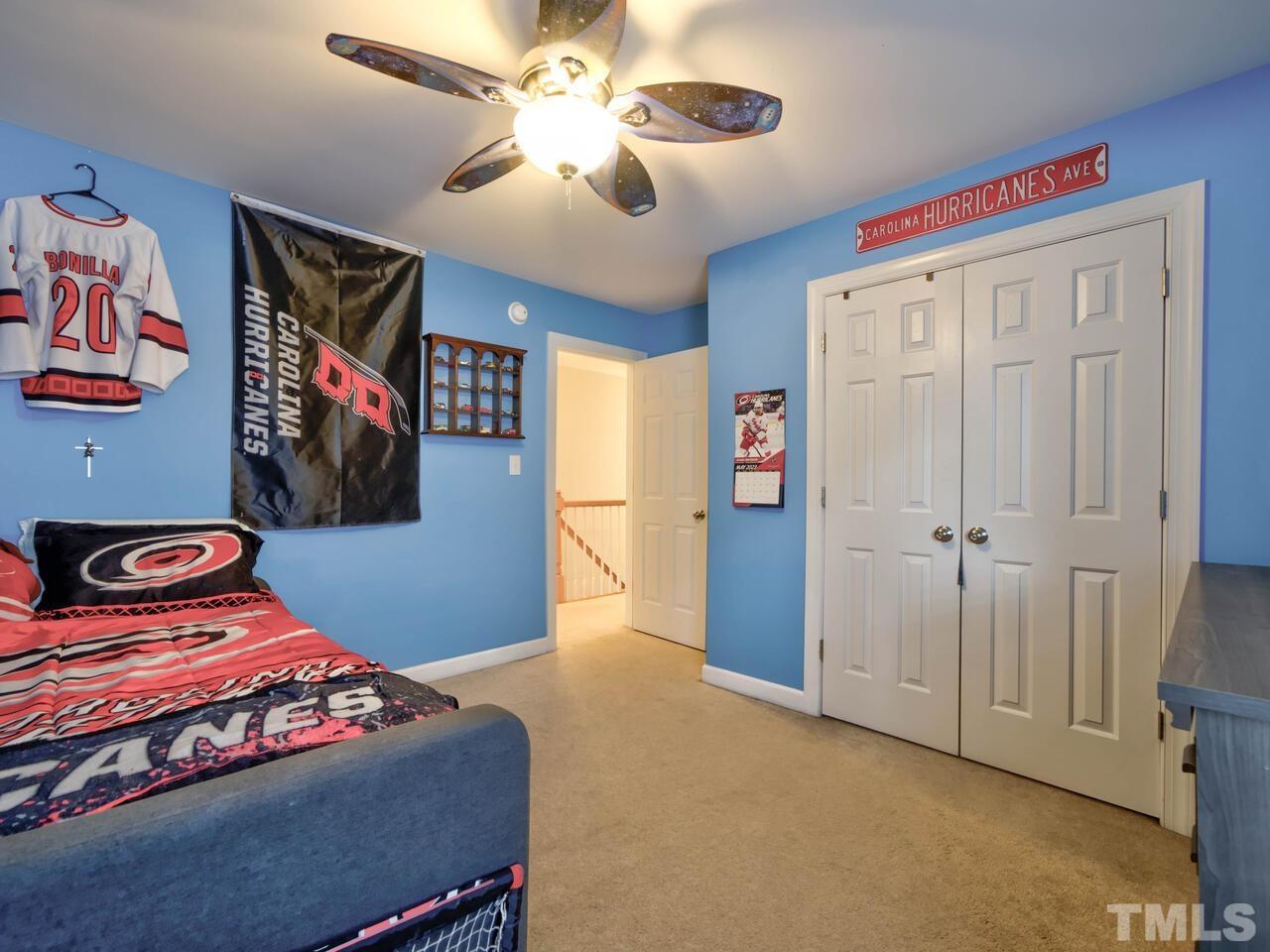 2228 Karns Place Raleigh, NC 27614 - Photo 30 of 62 a bedroom with a bed and a chandelier