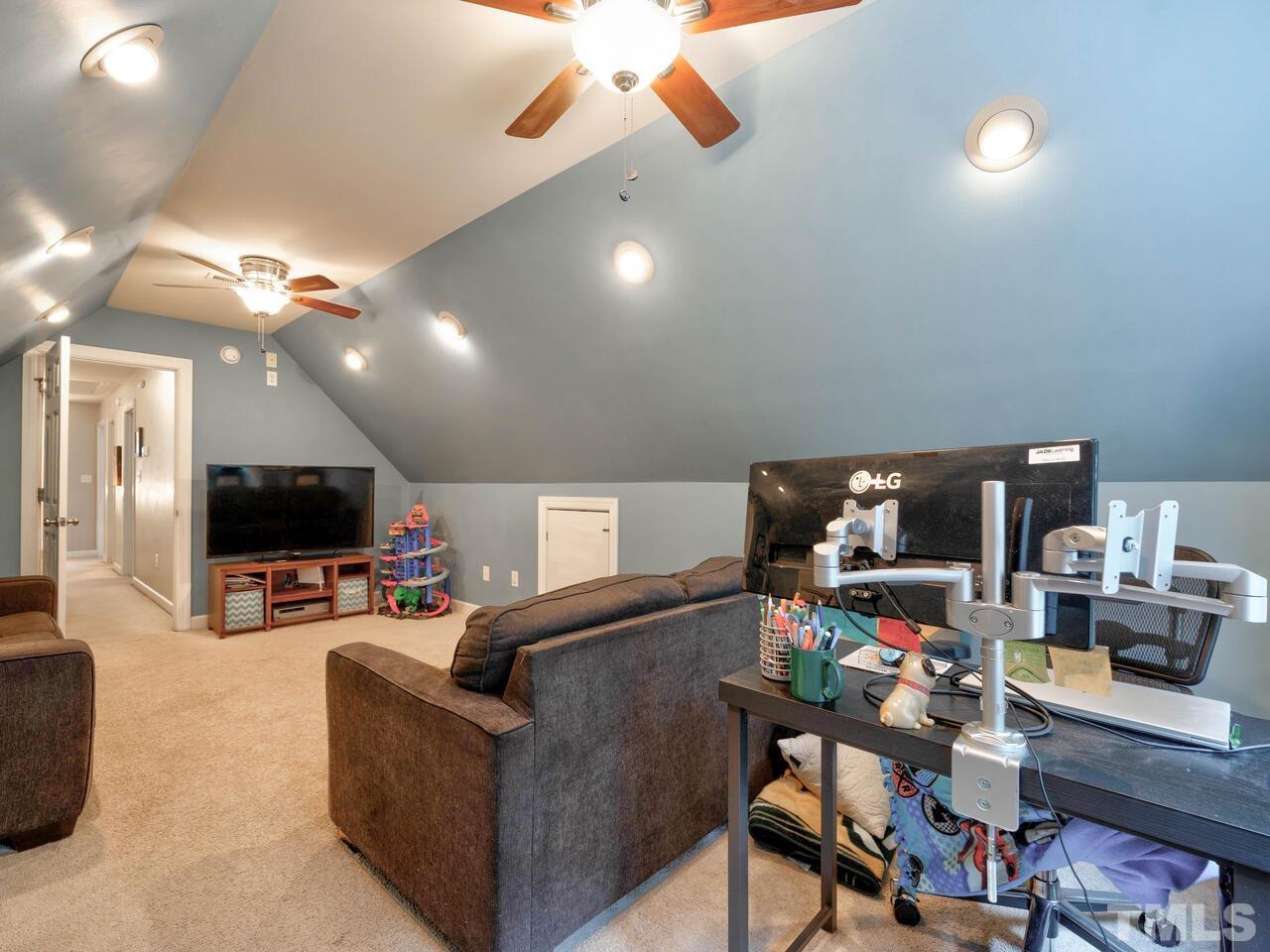 2228 Karns Place Raleigh, NC 27614 - Photo 36 of 62 a living room with furniture and a flat screen tv