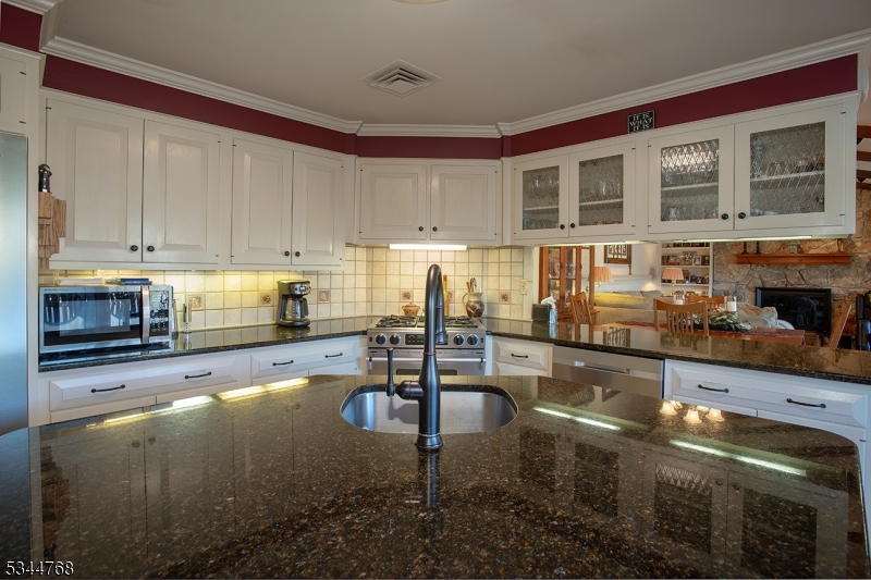 5 Marine Terrace Sparta, NJ 07871 - Photo 30 of 48 a kitchen with granite countertop a stove and cabinets