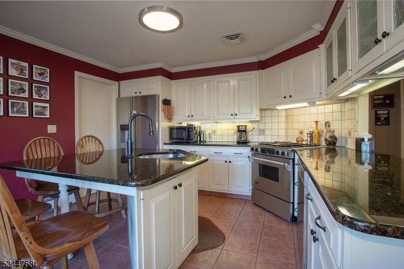 5 Marine Terrace Sparta, NJ 07871 - Photo 32 of 48 a kitchen with stainless steel appliances granite countertop a sink a stove and a refrigerator