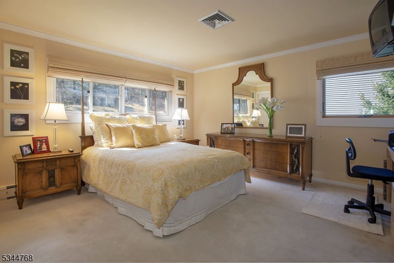 5 Marine Terrace Sparta, NJ 07871 - Photo 10 of 48 a bedroom with a large bed and a chandelier fan