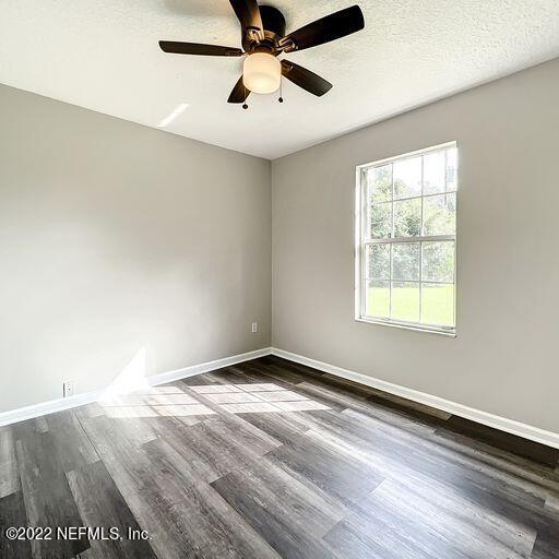 2950 Lakeside Villa Road Orange Park, FL 32073 - Photo 11 of 44 wooden floor in an empty room with a window