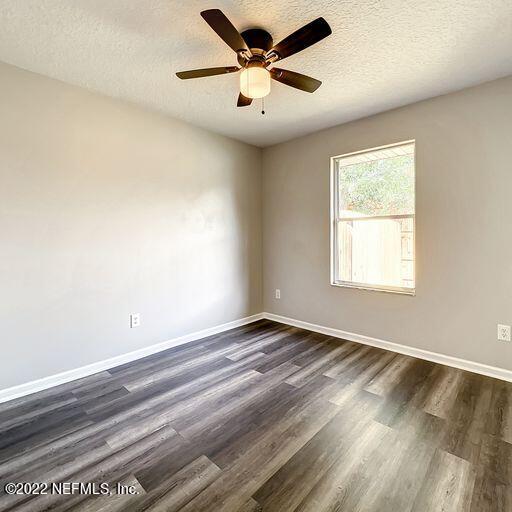 2950 Lakeside Villa Road Orange Park, FL 32073 - Photo 14 of 44 a view of an empty room with window and a ceiling fan