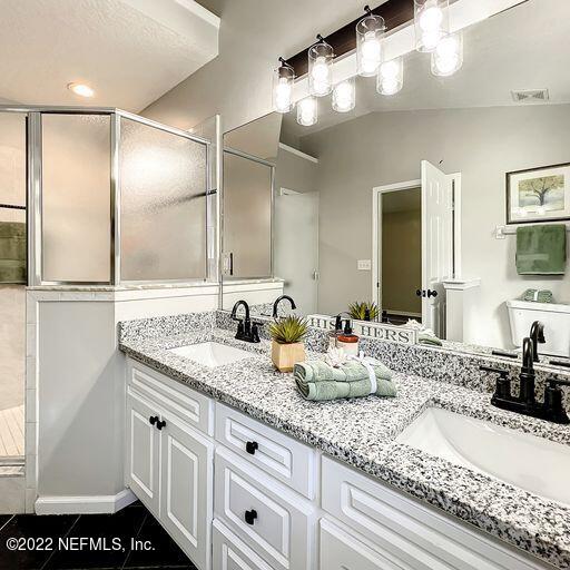 2950 Lakeside Villa Road Orange Park, FL 32073 - Photo 18 of 44 a bathroom with a granite countertop sink and a mirror