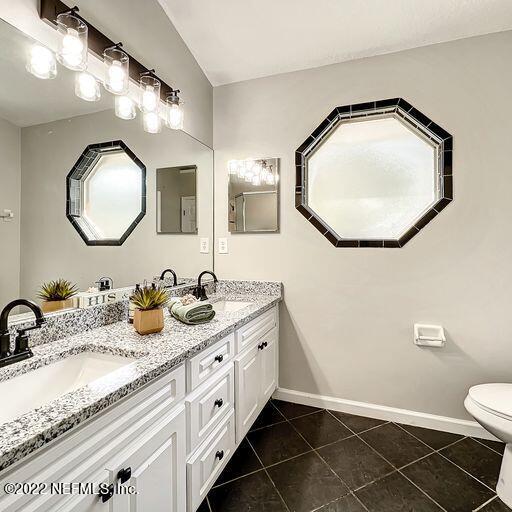 2950 Lakeside Villa Road Orange Park, FL 32073 - Photo 20 of 44 a bathroom with a granite countertop double vanity sink and a mirror
