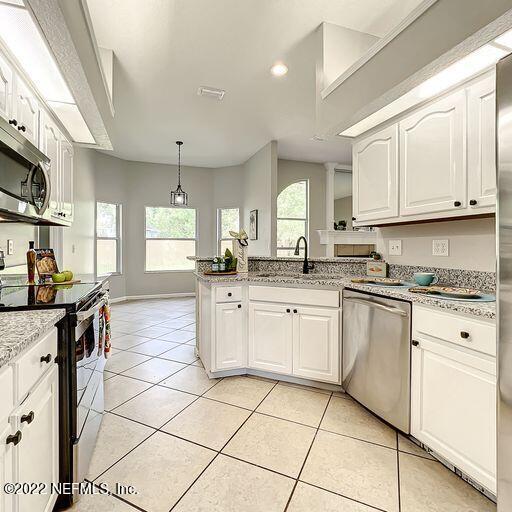 2950 Lakeside Villa Road Orange Park, FL 32073 - Photo 23 of 44 a kitchen with a sink window and cabinets