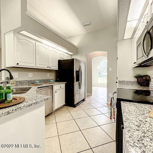 2950 Lakeside Villa Road Orange Park, FL 32073 - Photo 25 of 44 a kitchen with stainless steel appliances granite countertop a stove a sink and a refrigerator
