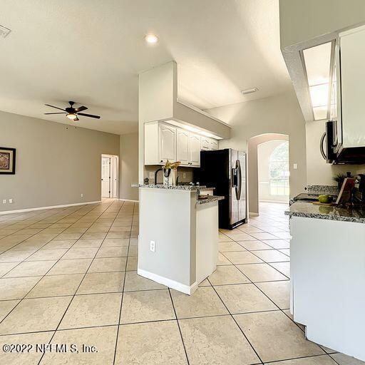 2950 Lakeside Villa Road Orange Park, FL 32073 - Photo 26 of 44 a kitchen with a sink a stove and cabinets