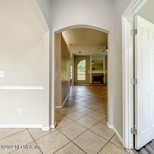2950 Lakeside Villa Road Orange Park, FL 32073 - Photo 32 of 44 a view of a hallway with wooden floor and a living room