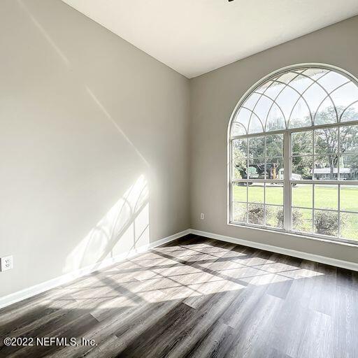 2950 Lakeside Villa Road Orange Park, FL 32073 - Photo 36 of 44 an empty room with wooden floor and windows