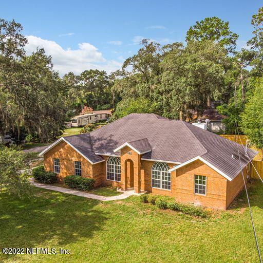 2950 Lakeside Villa Road Orange Park, FL 32073 - Photo 43 of 44 a view of a big house with a big yard and large trees