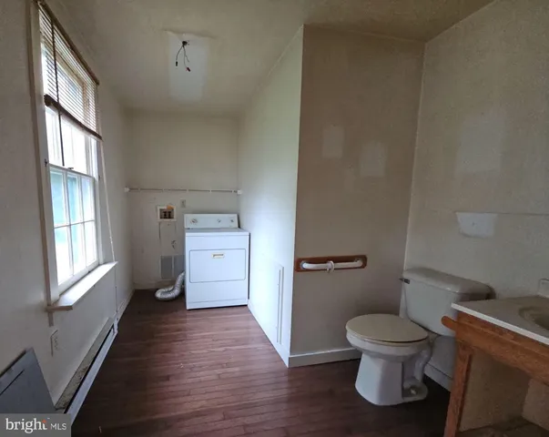 a bathroom with a toilet and a vanity