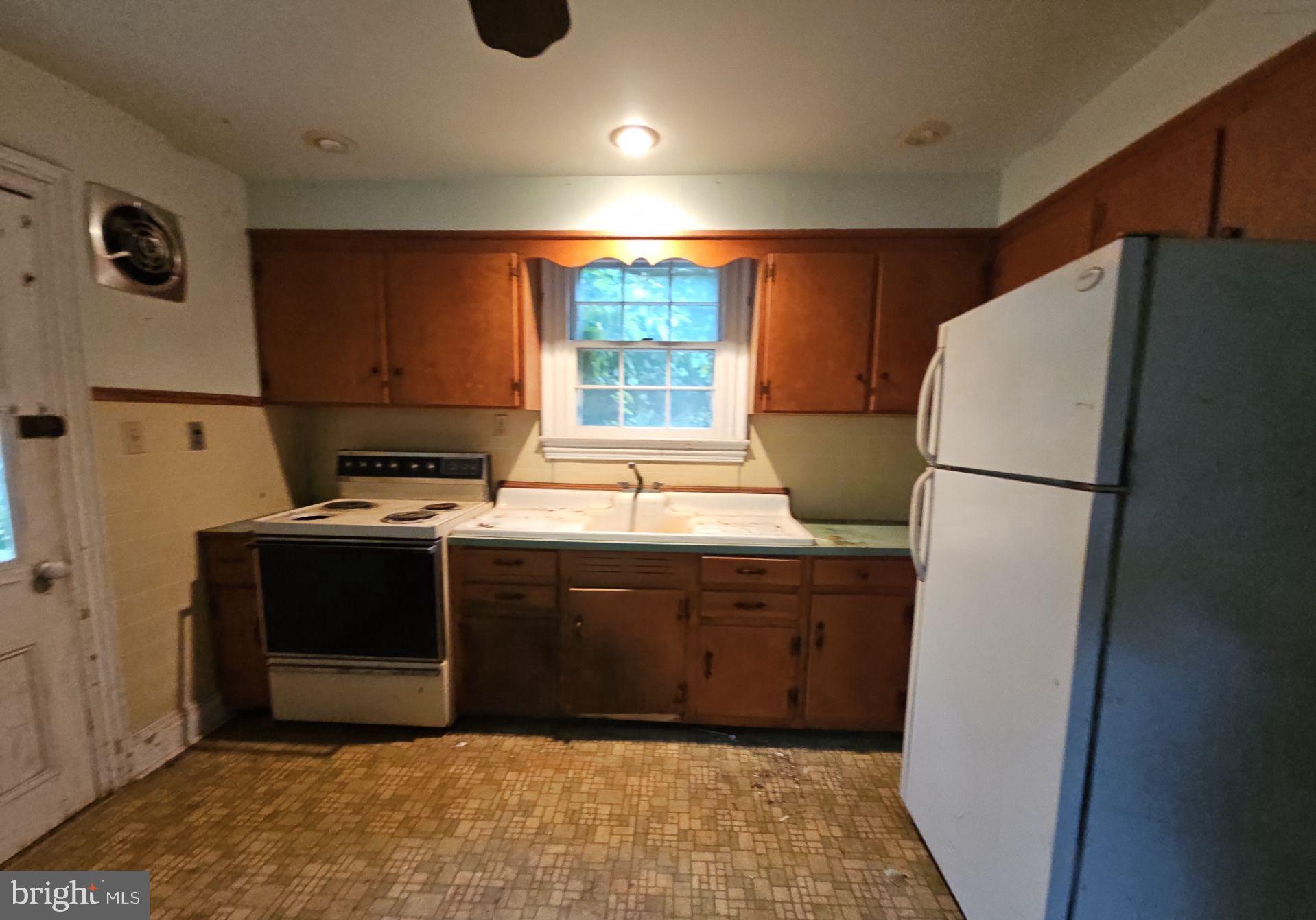 1223 Front Street Mauricetown, NJ 08329 - Photo 16 of 17 a kitchen with stainless steel appliances granite countertop a refrigerator and a sink