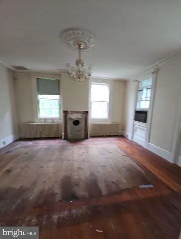 an empty room with windows and entrance