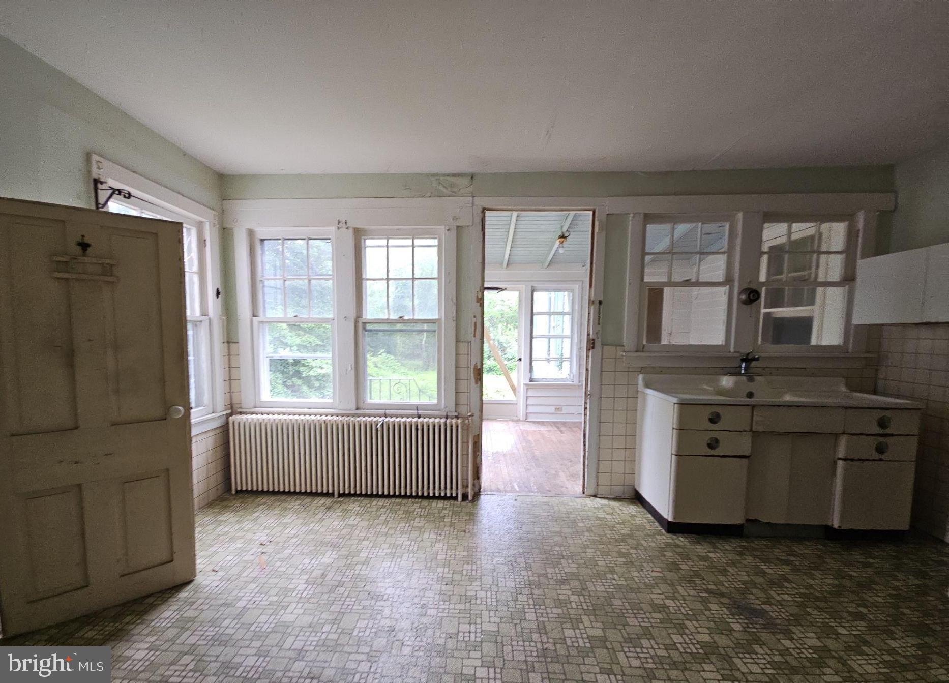 1223 Front Street Mauricetown, NJ 08329 - Photo 7 of 17 a room with kitchen island stainless steel appliances a stove a sink and a large window