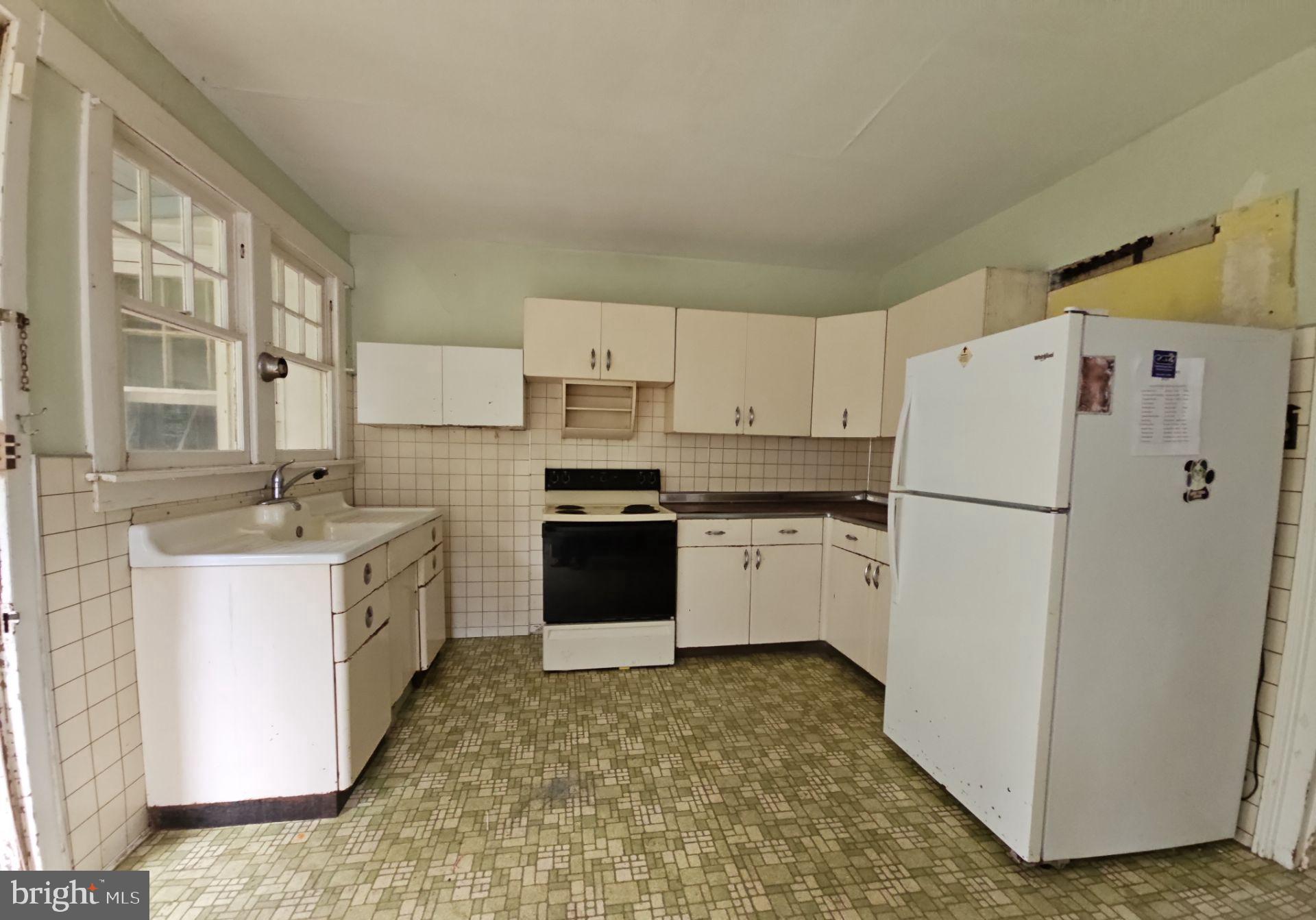 1223 Front Street Mauricetown, NJ 08329 - Photo 8 of 17 a kitchen with a refrigerator a sink and a stove