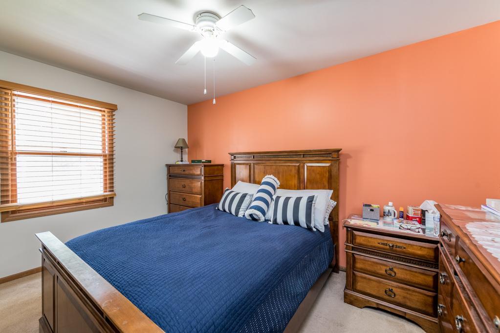 1702 Hebron Avenue Zion, IL 60099 - Photo 12 of 28 a bedroom with a bed and a chandelier