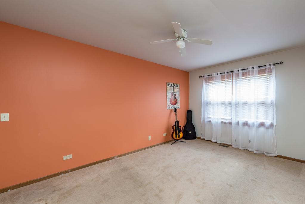 1702 Hebron Avenue Zion, IL 60099 - Photo 13 of 28 an empty room with windows and ceiling fan