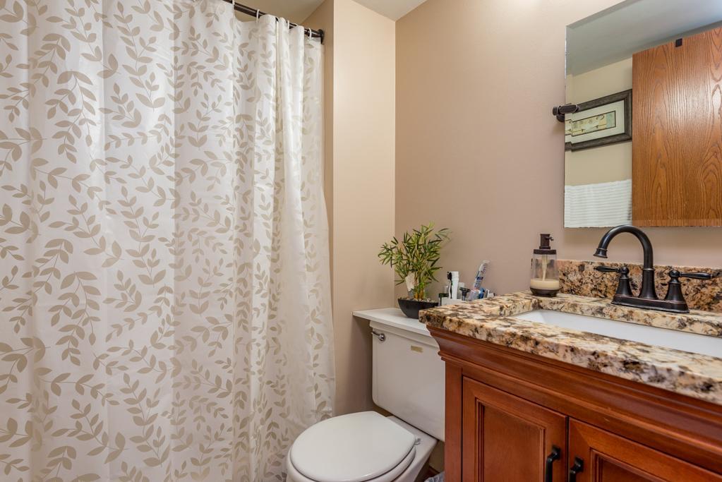 1702 Hebron Avenue Zion, IL 60099 - Photo 20 of 28 a bathroom with a granite countertop sink and a toilet