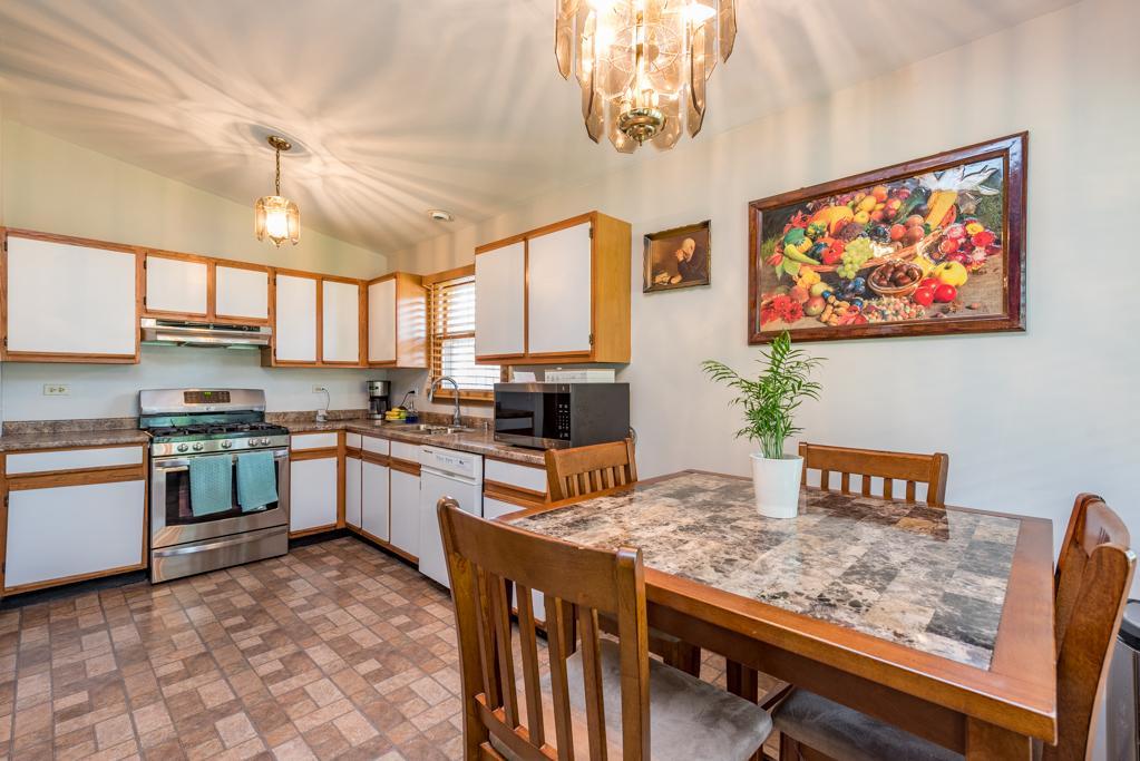 1702 Hebron Avenue Zion, IL 60099 - Photo 5 of 28 a kitchen with stainless steel appliances granite countertop a stove a sink dishwasher and cabinets