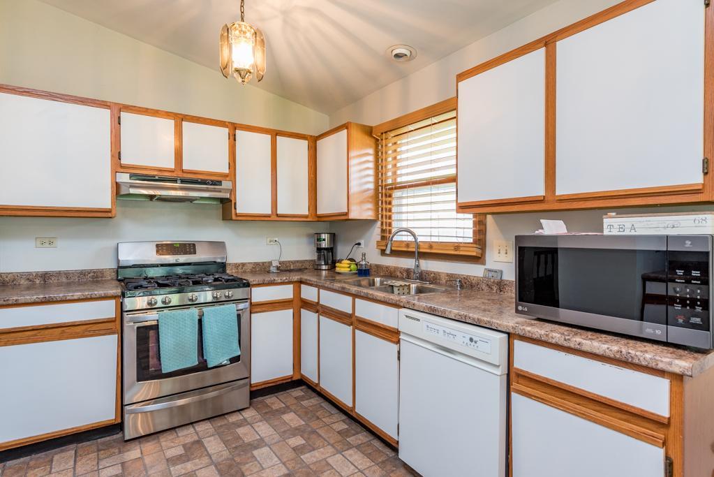 1702 Hebron Avenue Zion, IL 60099 - Photo 6 of 28 a kitchen with stainless steel appliances granite countertop a stove and a sink