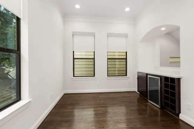 an empty room with windows and closet