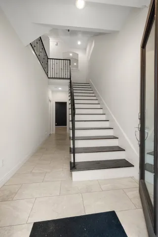 a kitchen with kitchen island granite countertop a sink appliances and cabinets