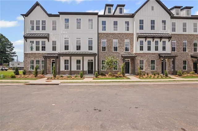 front view of a brick house with a swimming pool