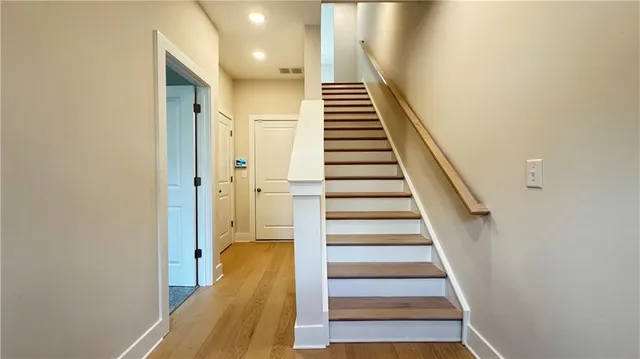 a view of entryway and hall with wooden floor