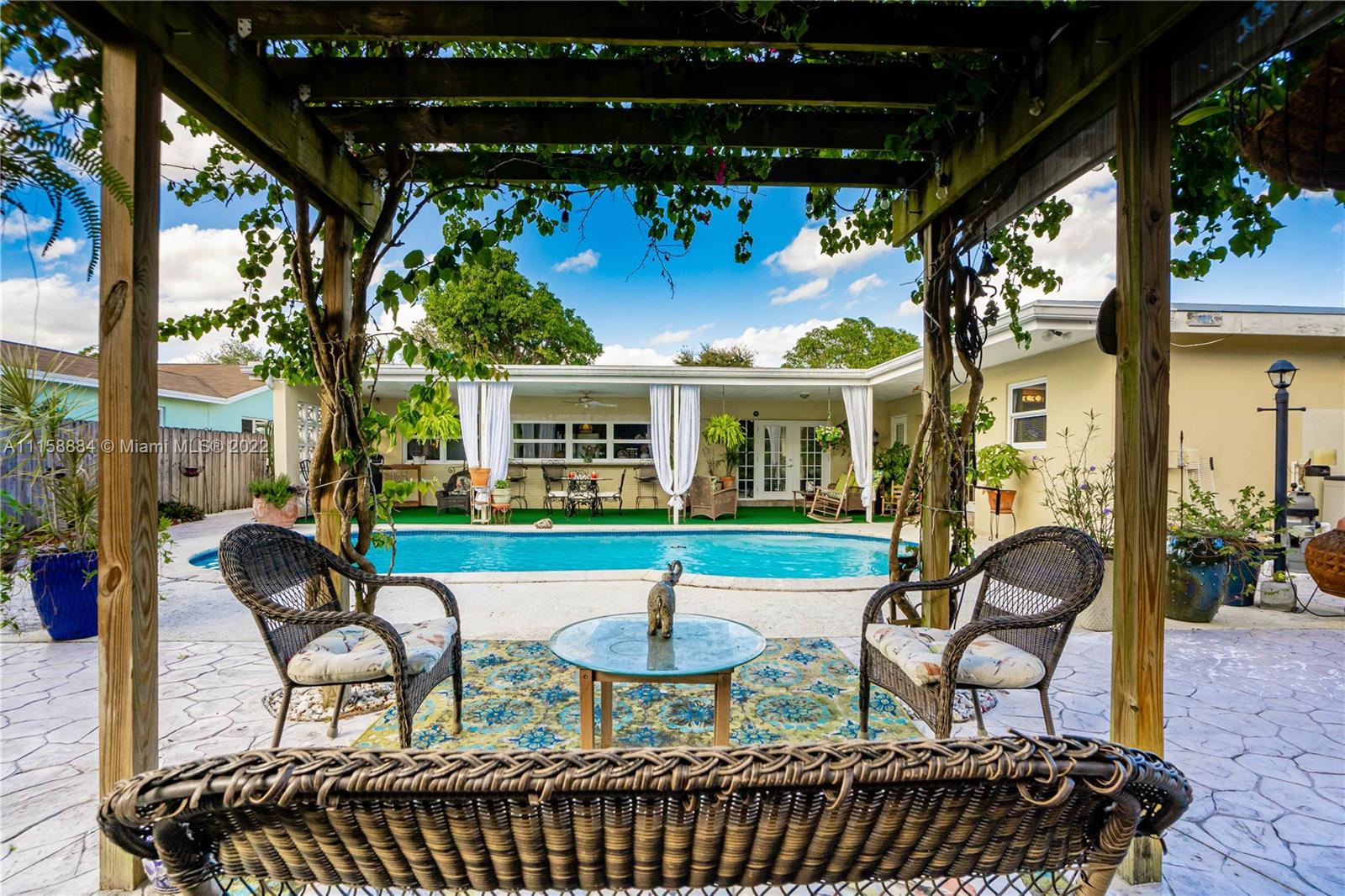 5012 Hayes Street Hollywood, FL 33021 - Photo 1 of 36 a view of a chairs and table in the patio
