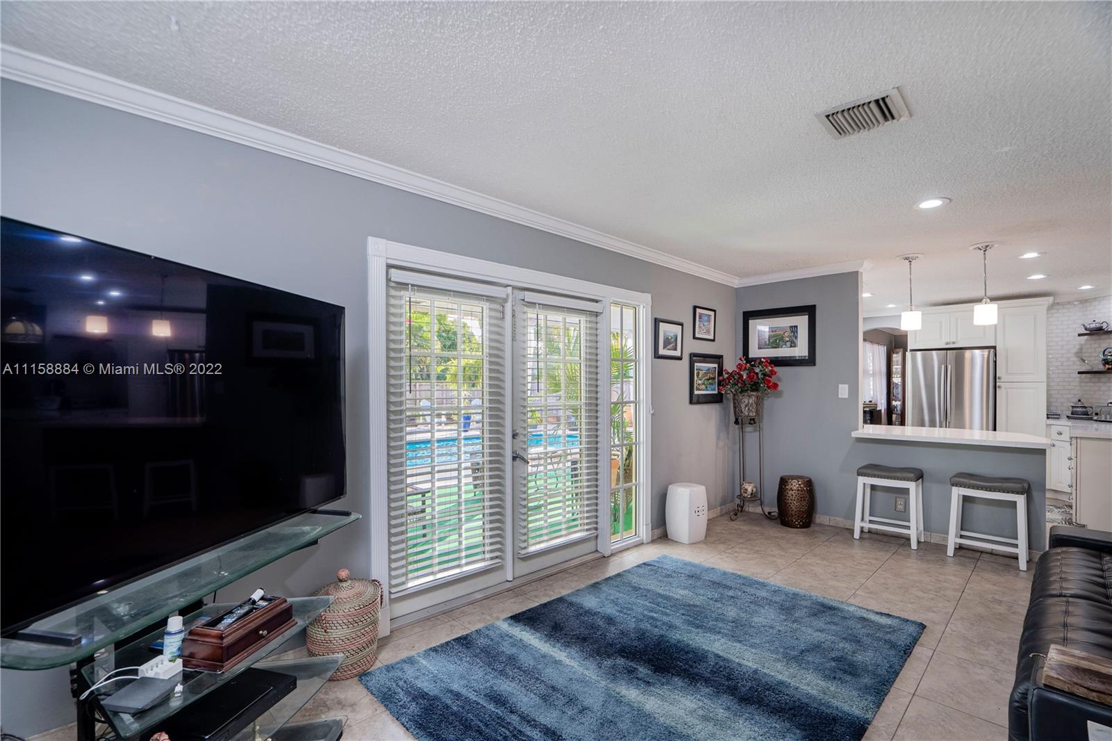 5012 Hayes Street Hollywood, FL 33021 - Photo 13 of 36 a living room with furniture rug and flat screen tv