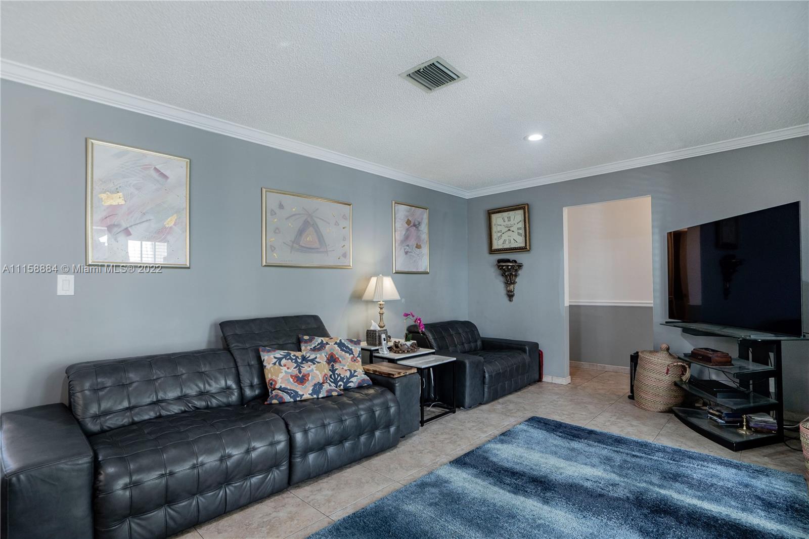 5012 Hayes Street Hollywood, FL 33021 - Photo 14 of 36 a living room with furniture a flat screen tv and a window