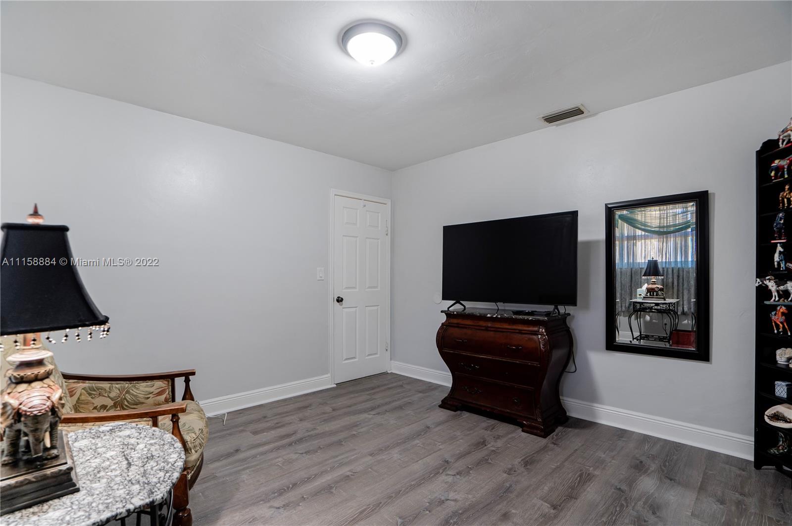 5012 Hayes Street Hollywood, FL 33021 - Photo 16 of 36 a living room with furniture and a flat screen tv