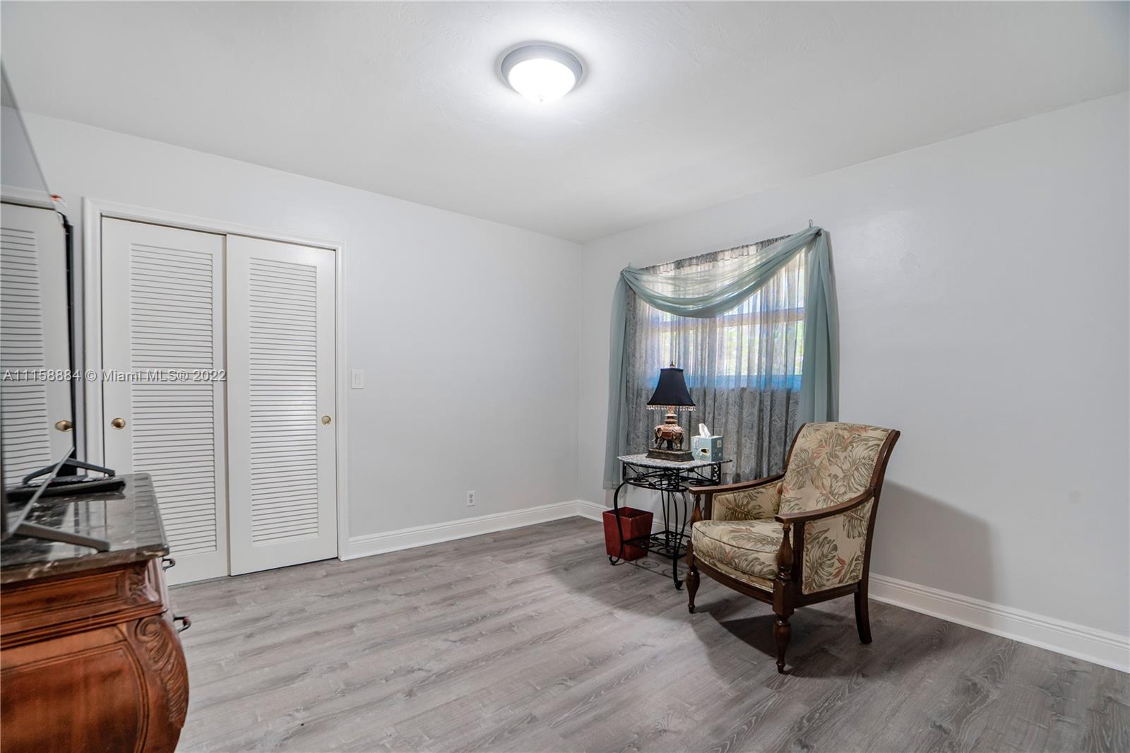 5012 Hayes Street Hollywood, FL 33021 - Photo 17 of 36 a living room with furniture and a floor to ceiling window