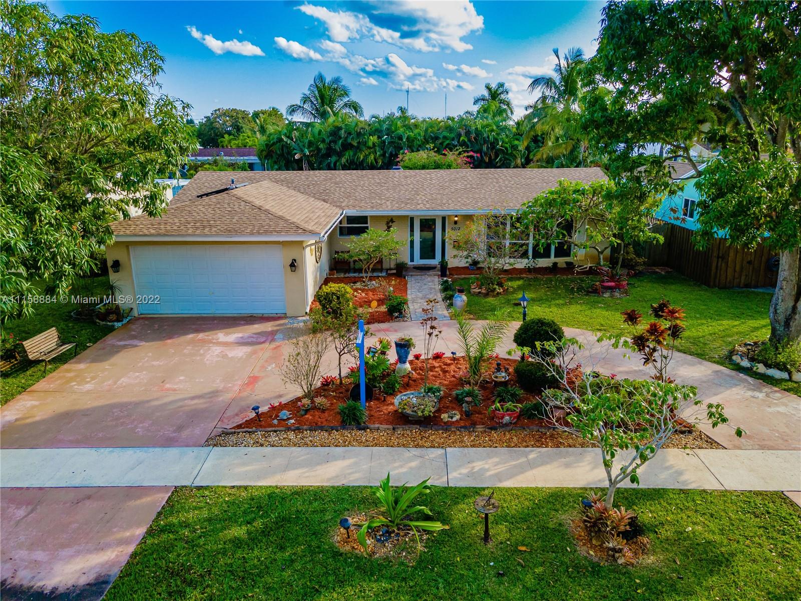 5012 Hayes Street Hollywood, FL 33021 - Photo 2 of 36 a view of a town with many windows and plants