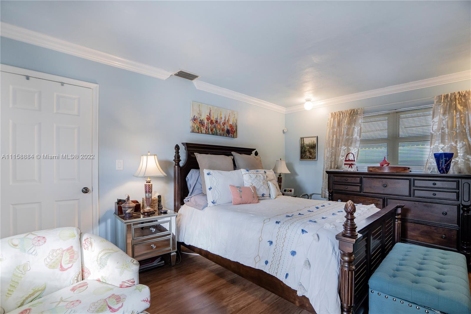 5012 Hayes Street Hollywood, FL 33021 - Photo 22 of 36 a bedroom with a bed and wooden floor