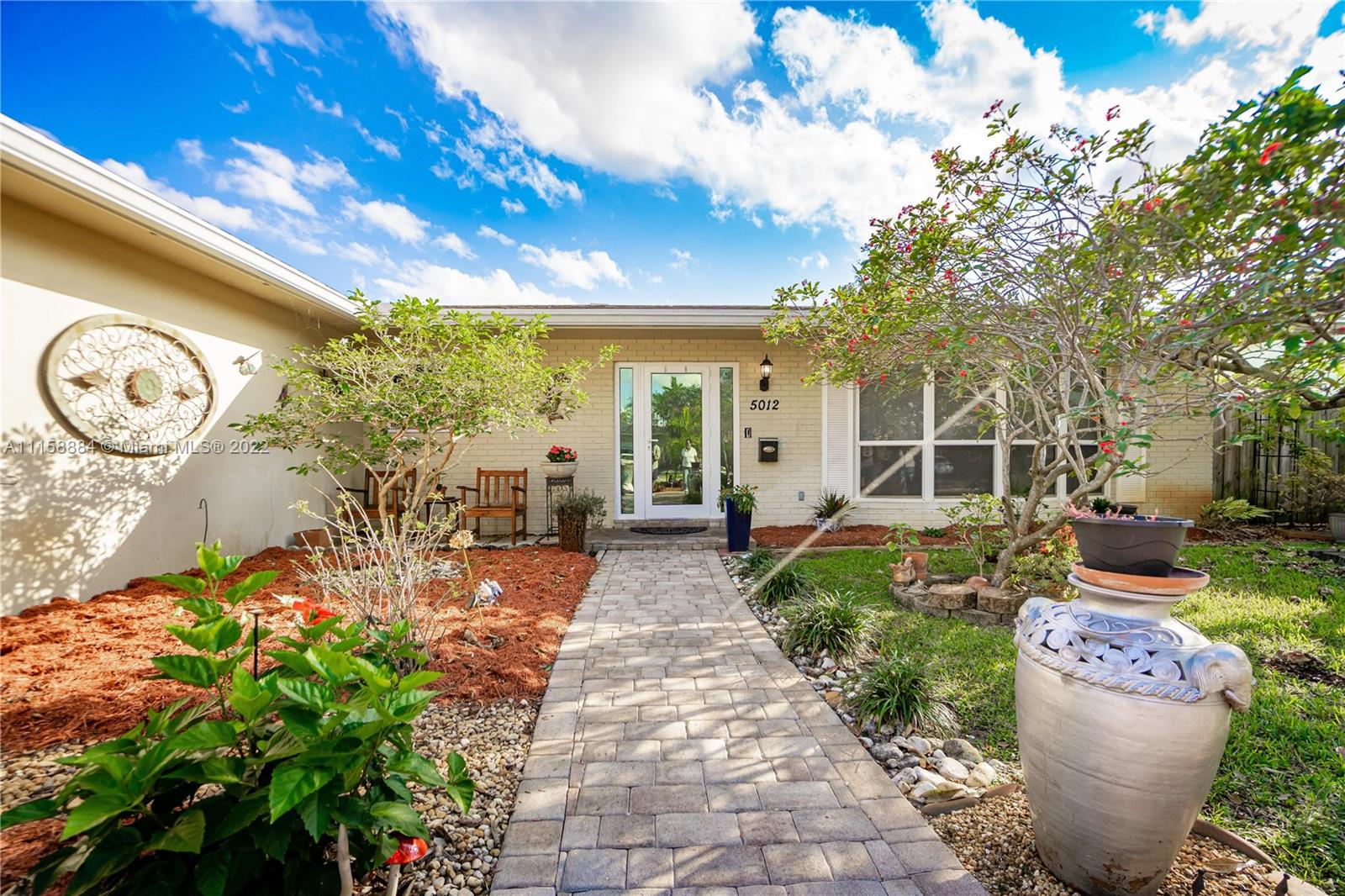 5012 Hayes Street Hollywood, FL 33021 - Photo 3 of 36 a view of a backyard with garden and patio