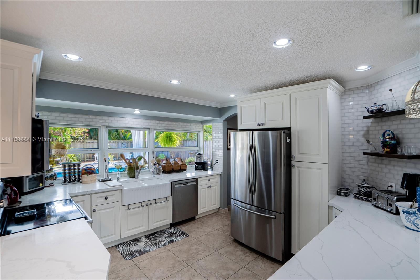 5012 Hayes Street Hollywood, FL 33021 - Photo 8 of 36 a kitchen with refrigerator and cabinets