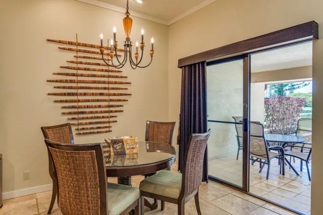 a view of a dining room with furniture and chandelier
