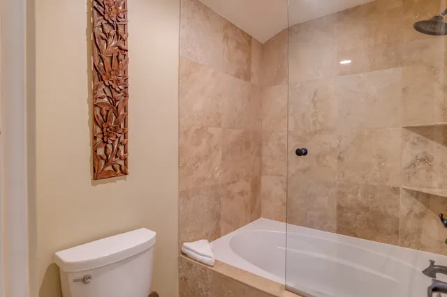 a bedroom with a large bed and a large window