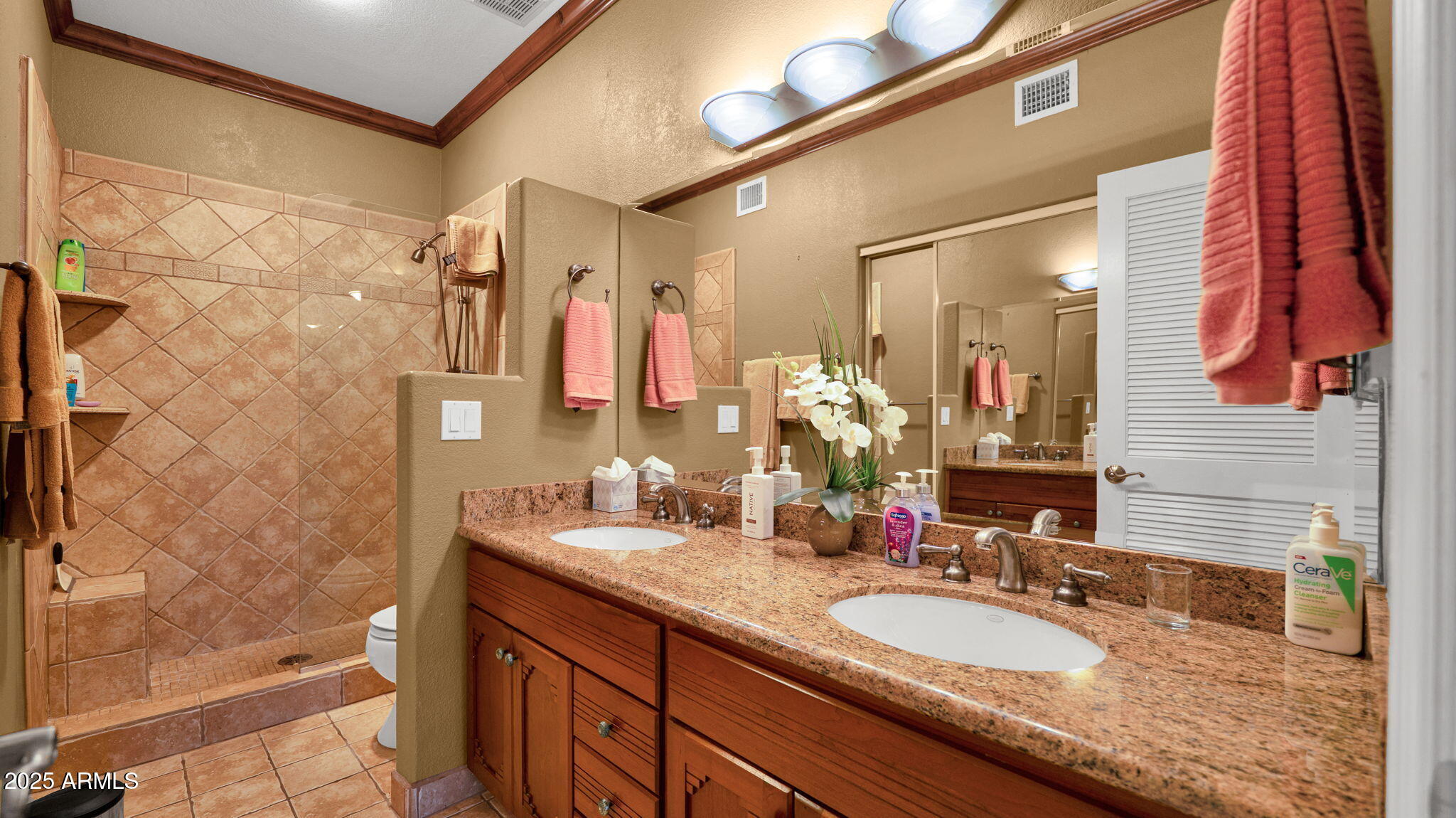 7710 East Gainey Ranch Road, Unit 113 Scottsdale, AZ 85258 - Photo 14 of 33 a bathroom with a granite countertop sink and a mirror