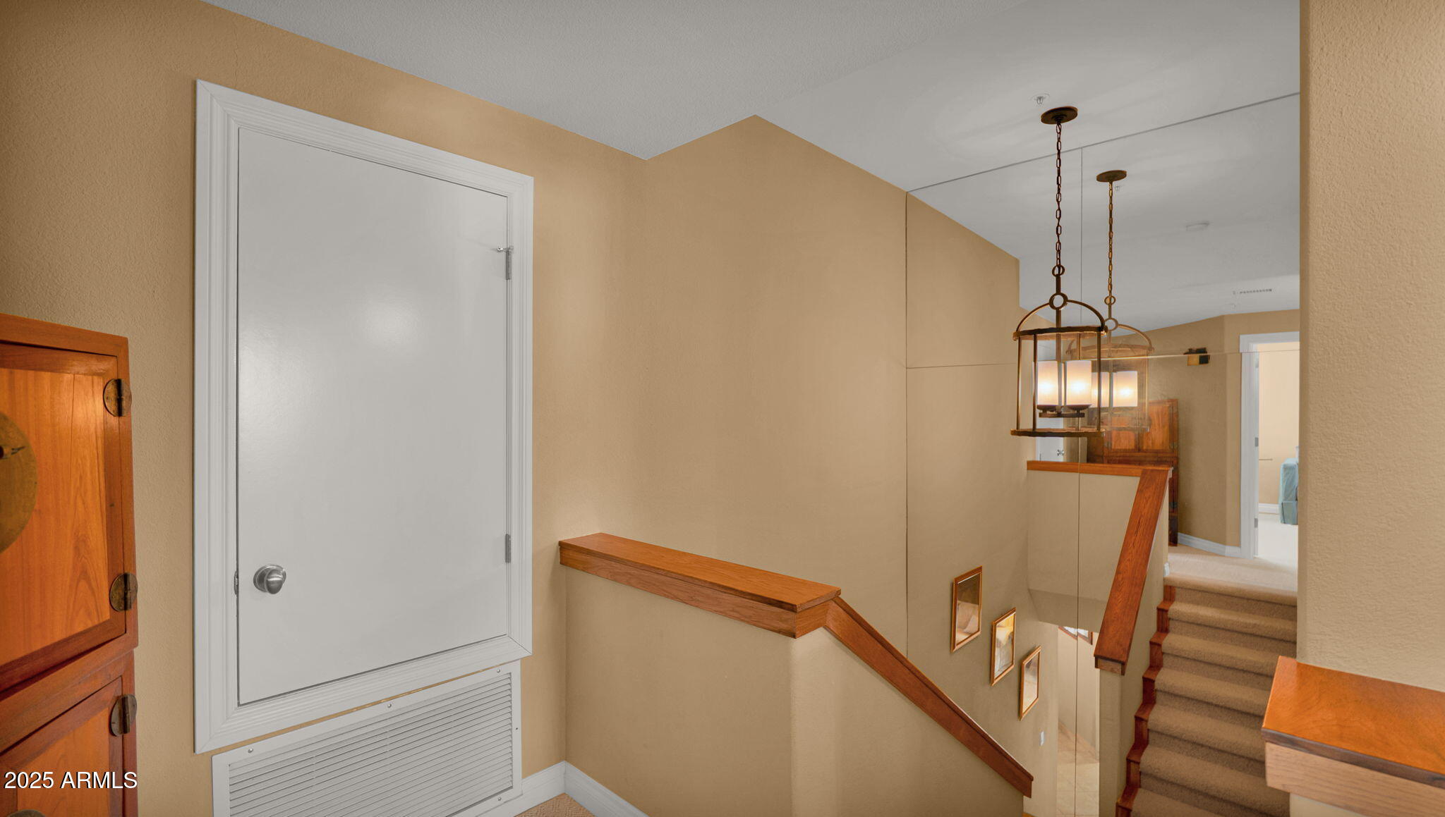 7710 East Gainey Ranch Road, Unit 113 Scottsdale, AZ 85258 - Photo 17 of 33 a view of a hallway with wooden floor and stairs