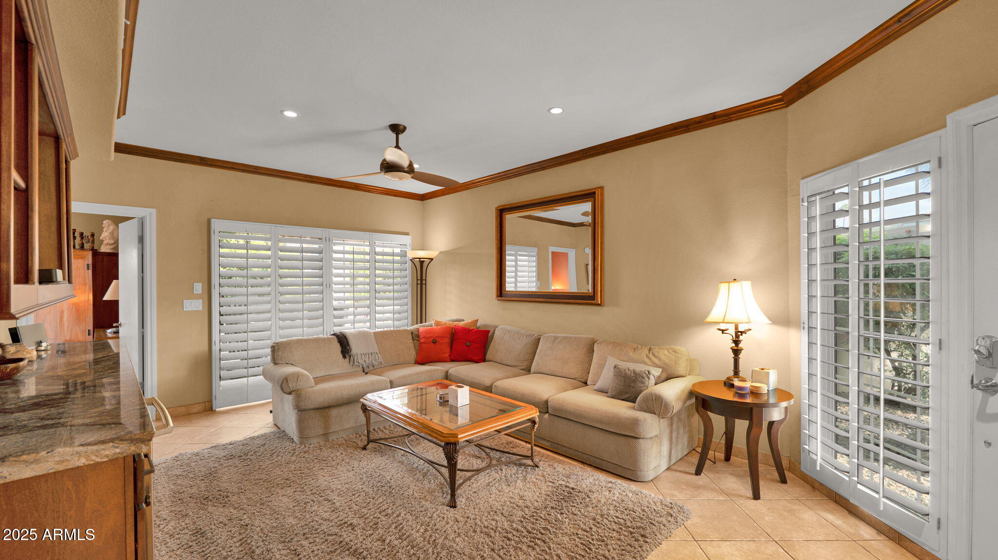 7710 East Gainey Ranch Road, Unit 113 Scottsdale, AZ 85258 - Photo 2 of 33 a living room with furniture and a lamp