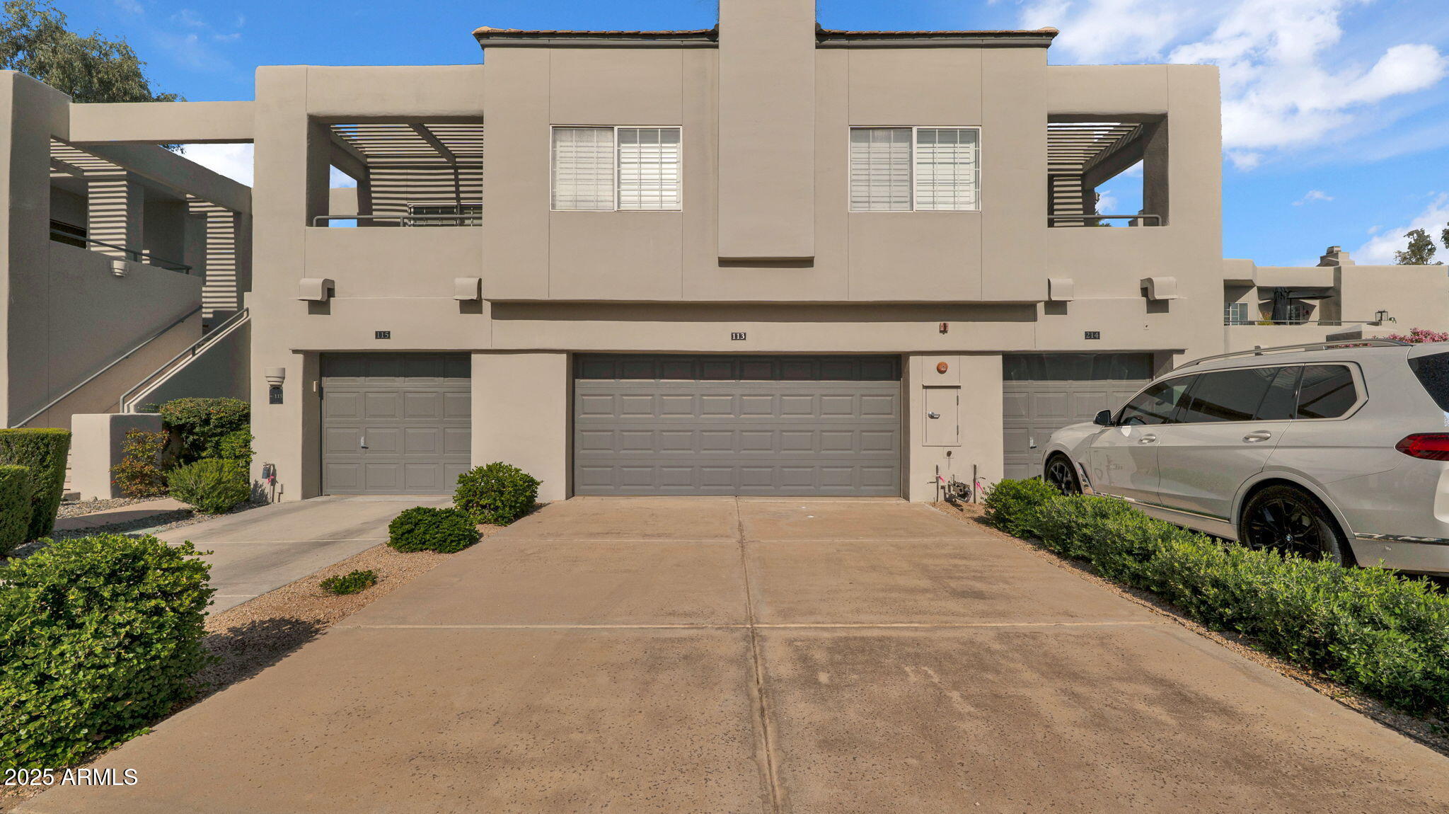 7710 East Gainey Ranch Road, Unit 113 Scottsdale, AZ 85258 - Photo 32 of 33 a front view of a house with a yard