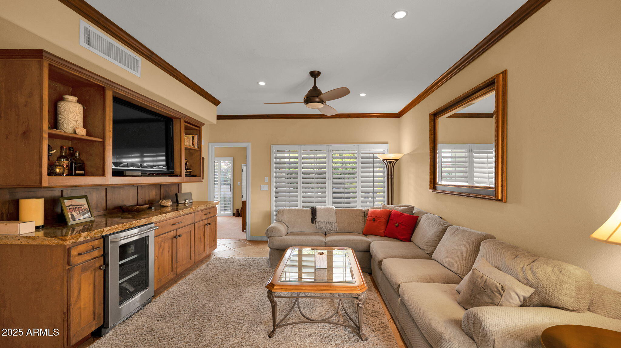 7710 East Gainey Ranch Road, Unit 113 Scottsdale, AZ 85258 - Photo 4 of 33 a living room with furniture and a flat screen tv