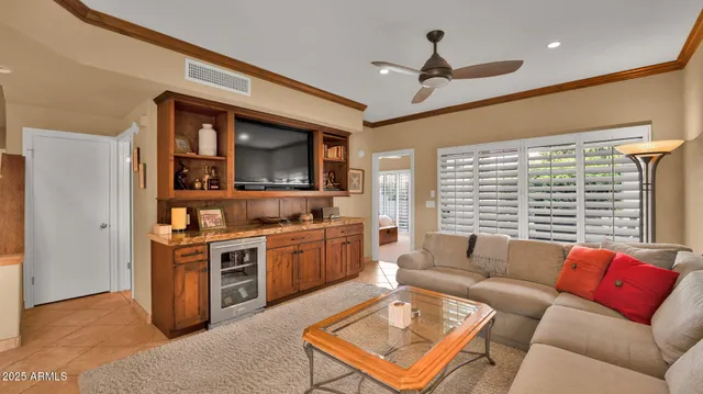 a living room with stainless steel appliances granite countertop furniture a rug and a window