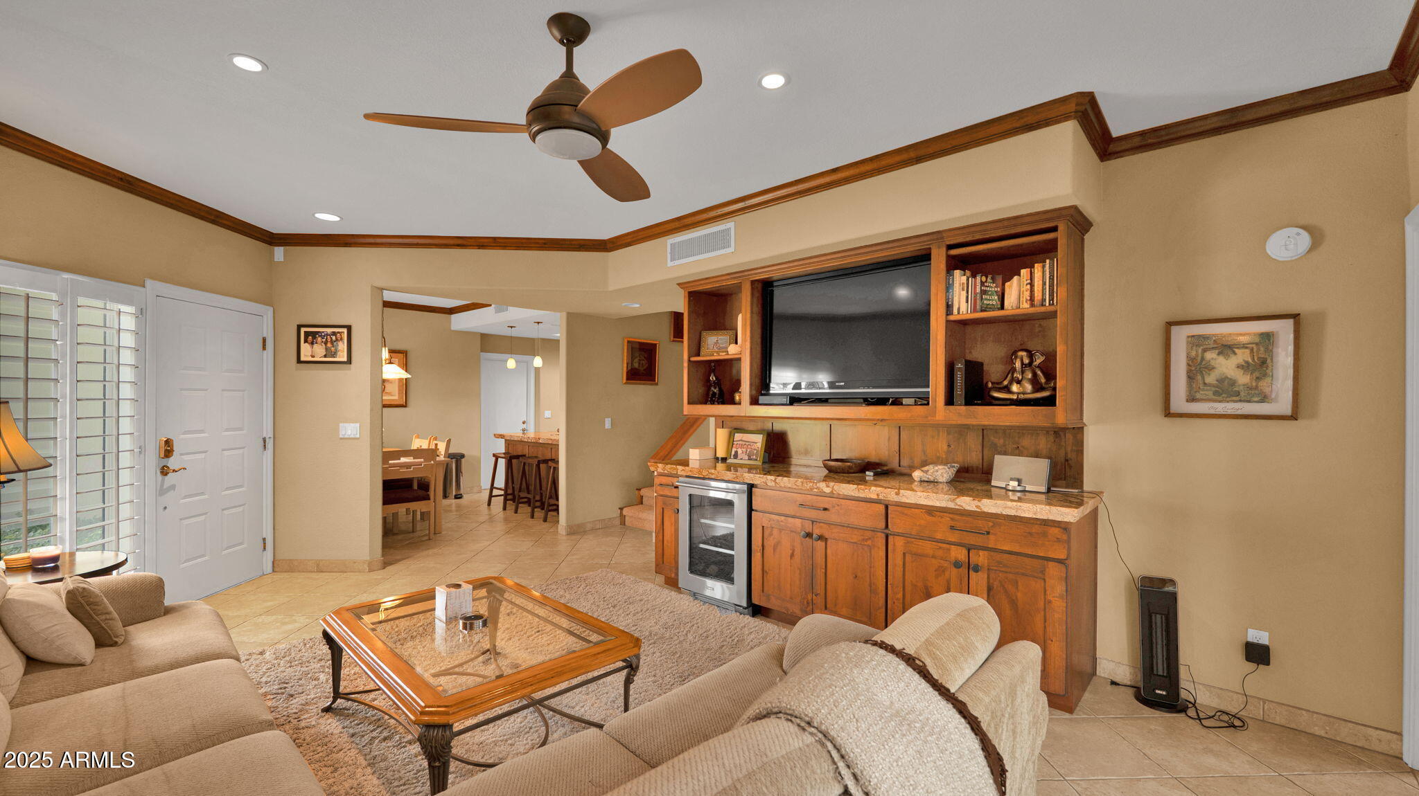 7710 East Gainey Ranch Road, Unit 113 Scottsdale, AZ 85258 - Photo 6 of 33 a living room with furniture a ceiling fan and a rug